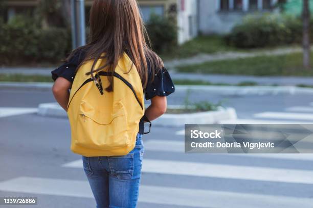 School Girl With Yellow School Bag On A Crosswalk Stock Photo - Download Image Now - Child, Education, Backpack