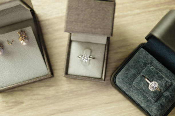 istock Diamond ring in jewelry gift box on wood table 1339739105