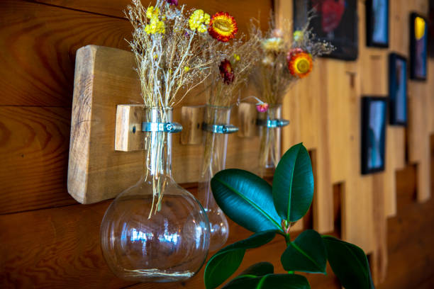 istock Plants in a glass flask hanging on the wall 1339739380