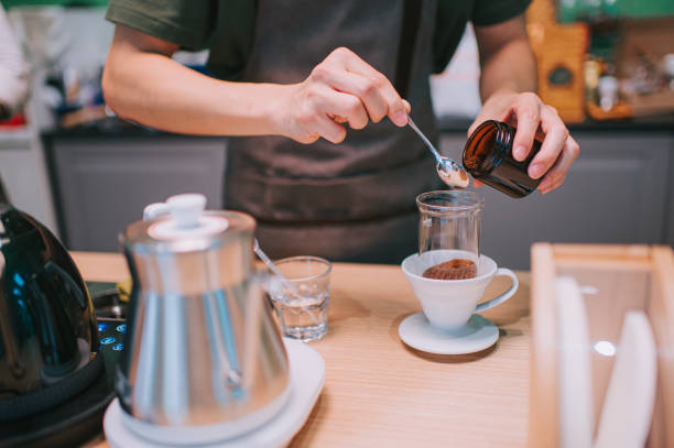 istock asian chinese senior male barista adding roasted coffee grounds preparing cold brew ice drip coffee in cafe coffee shop 1339743934