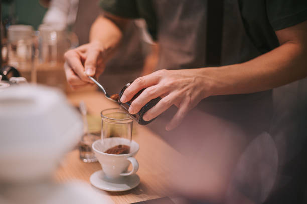 istock asian chinese senior male barista adding roasted coffee grounds preparing cold brew ice drip coffee in cafe coffee shop 1339743973