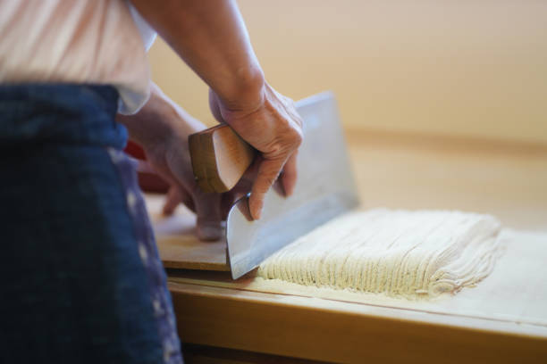 istock Hands of a man who cuts buckwheat 1339744809