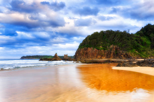 Scenic basalt headland off Jones beach in Kiama Bombo on South Coast of Australia NSW. Sunset seascape with famous cathedral rock.