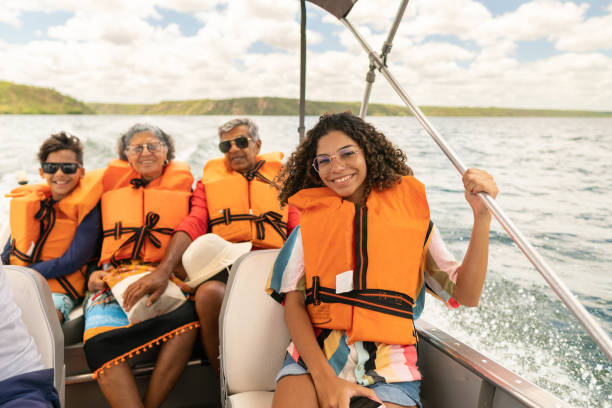 Boat tour on the São Francisco River Grandparents and grandchildren boating on the São Francisco River in Canindé, Sergipe, Brazil family motorboat stock pictures, royalty-free photos & images