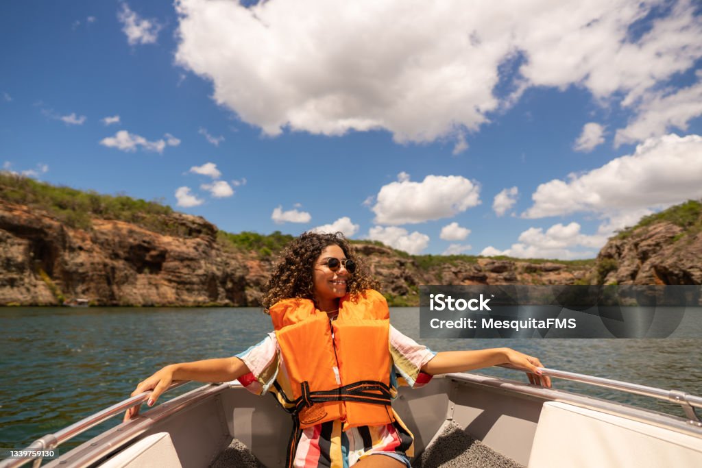 Boat tour on the São Francisco River in Alagoas Teen girl taking a boat on the São Francisco River in Canindé, Sergipe, Brazil Nautical Vessel Stock Photo