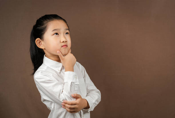 istock Little Girl Think on Brown Background 1339762220