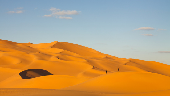 Tourists in the sand dunes of the Sahara Desert, Libya