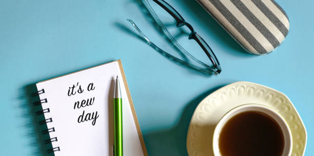 istock Top view of notepad with words, it's a new day 1339765940