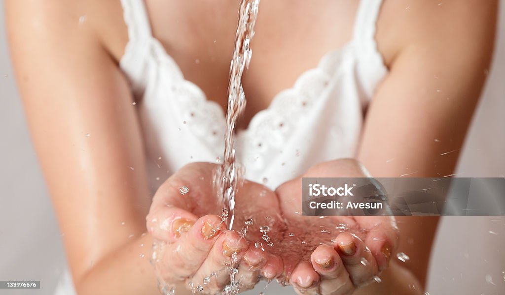 young girl washes with clean water Beautiful young girl washes with clean water at early morning Adult Stock Photo