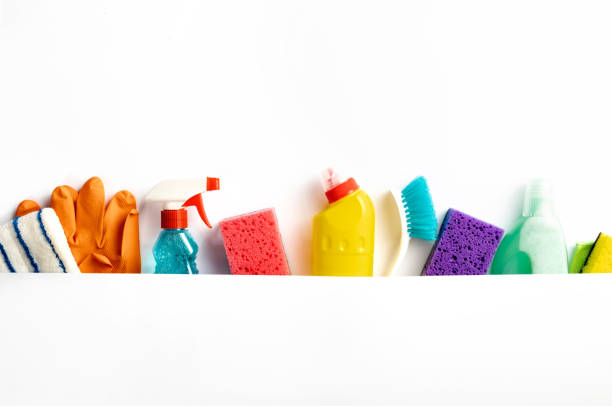 Set of various cleaning supplies on white background with copy space, top view