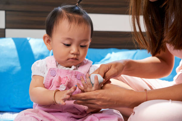 istock Mother Cleaning Hands of Daughter 1339772202