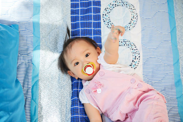 istock Adorable Baby Girl with Pacifier 1339772212