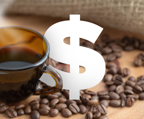 istock dollar symbol between coffee beans and brown cup. 1339779042