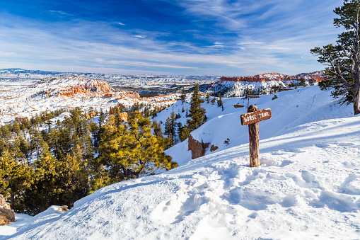 Horse trail sign post in Bryce Canyon National Park in Winter covered with snow