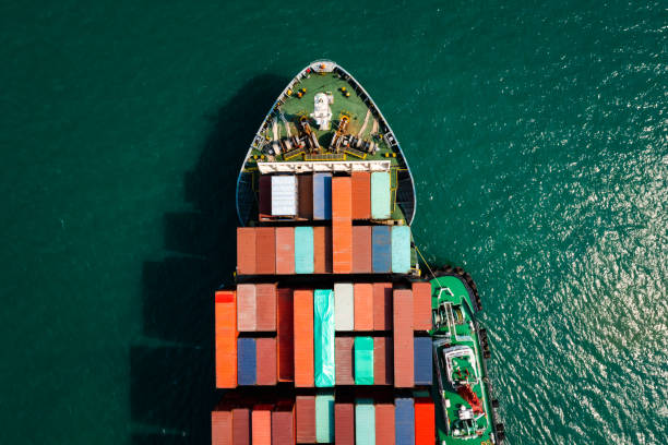 istock Aerial top view head shot from drone camera container cargo ship in import export business and industrial service commercial trade logistic and transportation of international by container cargo ship in the open sea, 1339783881