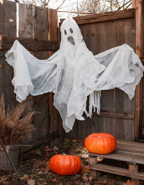 istock creepy fake ghost in Halloween decorated yard 1339783923