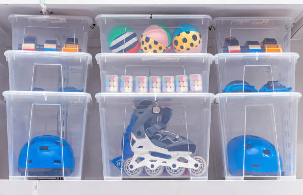 Plastic boxes with children's toys, rollers and a helmet. Plastic boxes with children's toys, rollers and a helmet. box container stock pictures, royalty-free photos & images