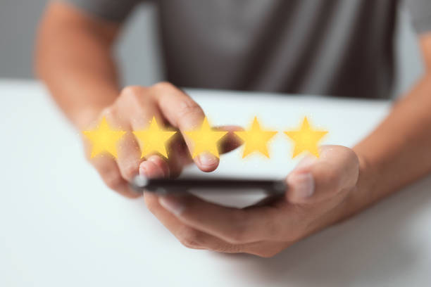 istock Customer service experience and business satisfaction survey. Man hand using smart phone with icon five star symbol to increase rating of company concept 1339786153