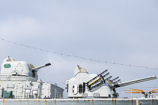 Chaff launcher is seen on the deck of a military ship sailing on the sea.