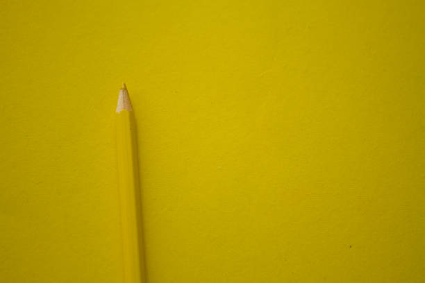 istock Yellow pencil on yellow background 1339787936
