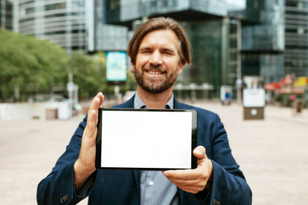 istock Mature businessman holding digital tablet with white screen 1339789065