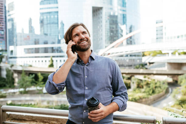istock Mature businessman drinking coffee outside and using smart phone 1339789623