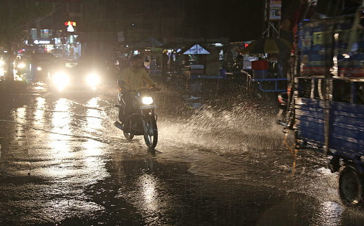 Beawar, Rajasthan, India, September 11, 2021: Vehicles wade through waterlogged road during heavy rain in Beawar.