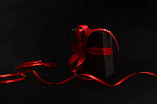 Black friday sale concept with gift box with ribbon, close-up