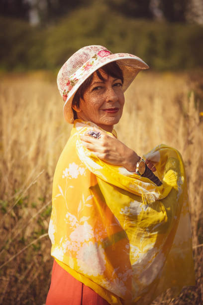 istock 40's lady in orange in the park 1339793468