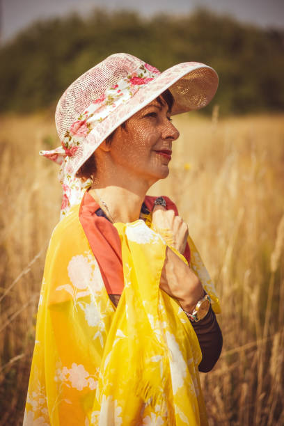 istock 40's lady in orange in the park 1339793474