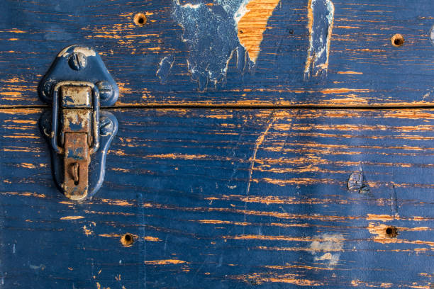 Blue latch on worn old blue wooden box, background, landscape orientation.