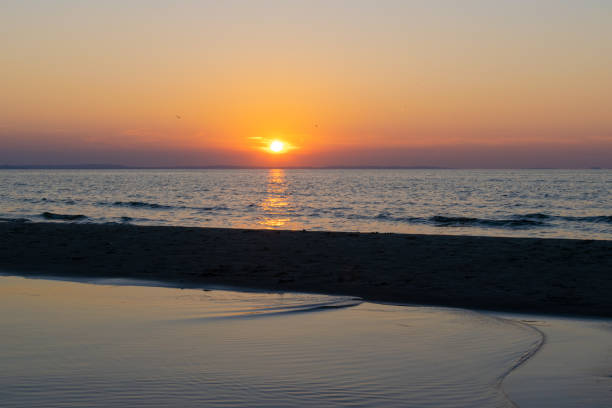 istock the setting sun against the backdrop of a calm sea 1339796201