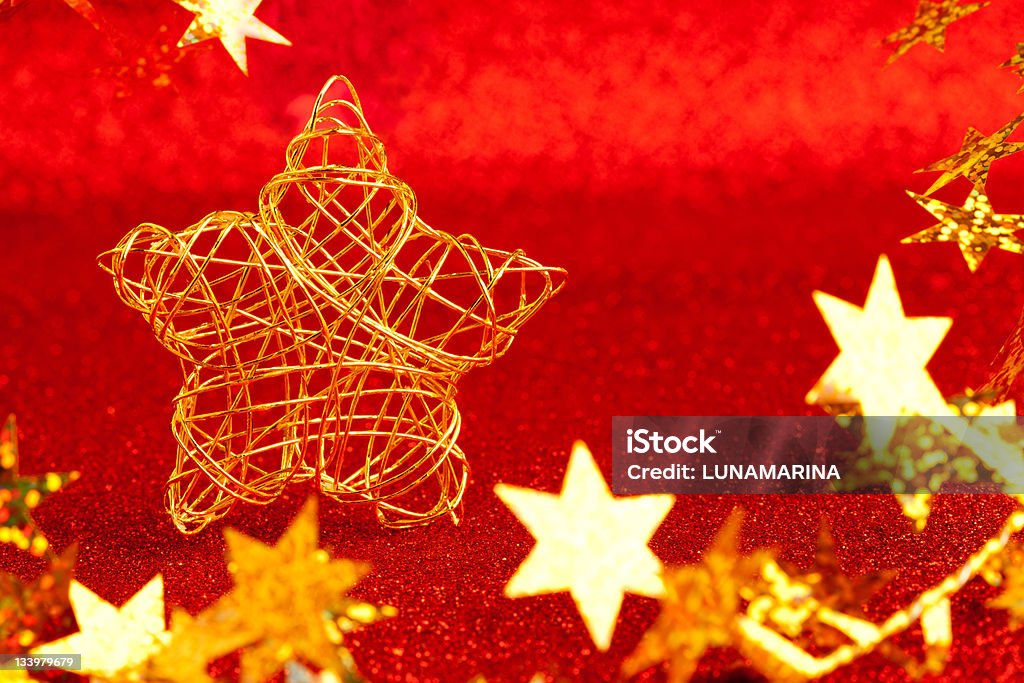 christmas gold wire star on red glitter christmas gold wire star on red glitter background Bright Stock Photo