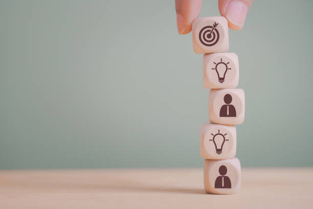 istock hand holding dart icon on wood block stack , strategy business method to target, brainstorming manpower to success, business concept 1339798687