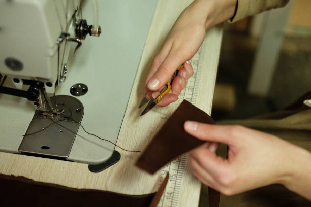 istock Closeup on woman sewing leather handbag 1339799926