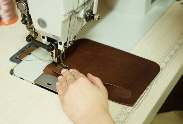 istock Closeup on woman sewing leather handbag 1339799933