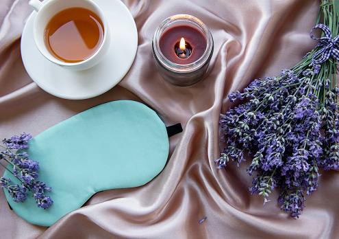 Healthy sleep concept. Lavender bouquet, lavender tea and sleep mask