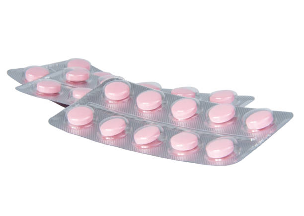 istock Pink pills for virus medcine isolated on the white 1339802153