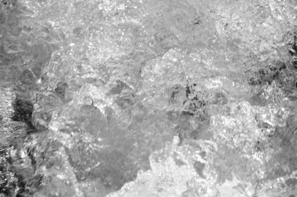 istock blurred background, texture of a bubbling stream of clear water 1339805023
