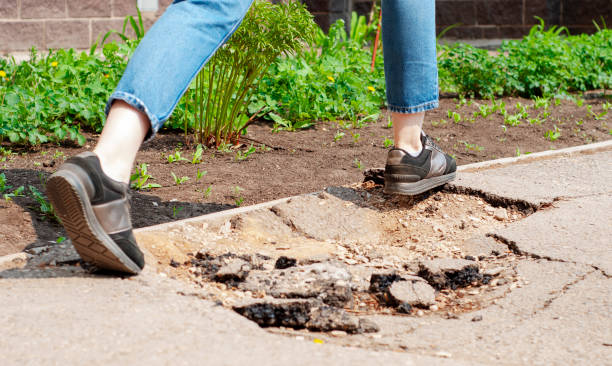 istock a man's feet step over a hole in the asphalt 1339805088