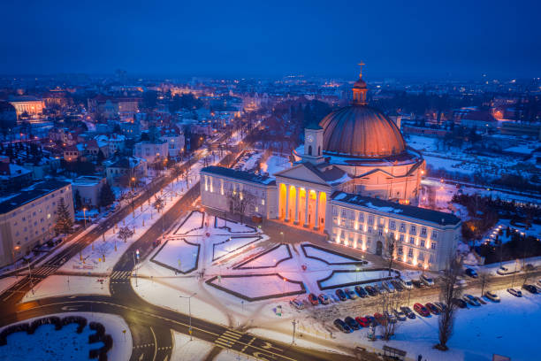 Snowy catholic Basilica in Bydgoszcz at night. Aerial view of architecture in Poland