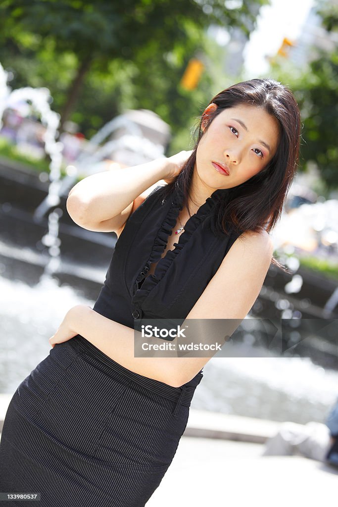 Attractive Young Woman An attractive young woman brushing back her hair with her hand. 20-29 Years Stock Photo