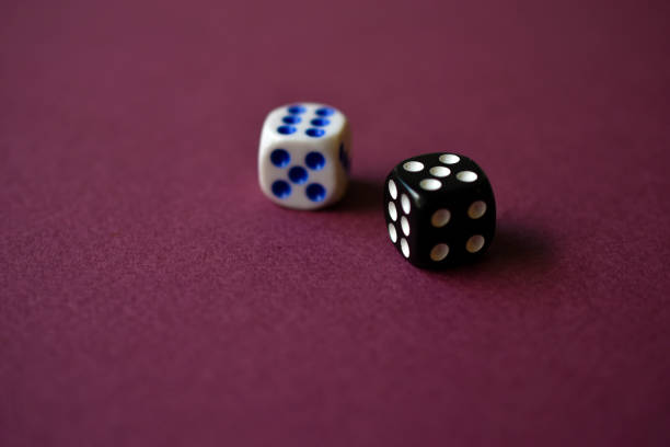istock Dice in black and white on a red background 1339809448