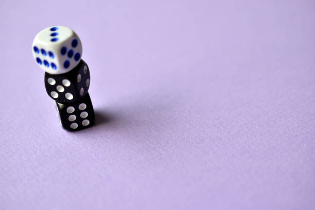 istock Dice  are black and white on a purple background 1339809485