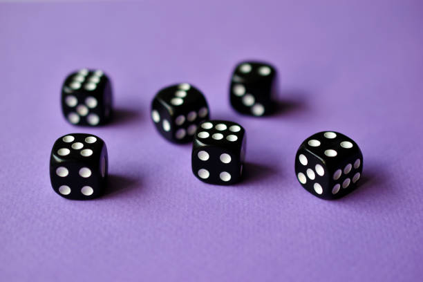 istock Dice  are black and white on a purple background 1339809515