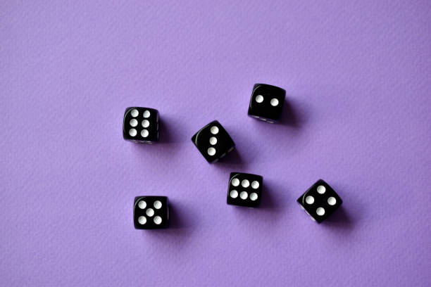 istock Dice  are black and white on a purple background 1339809518