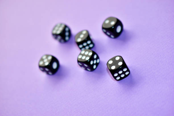 istock Dice  are black and white on a purple background 1339809523