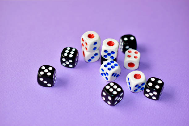 istock Dice  are black and white on a purple background 1339809530