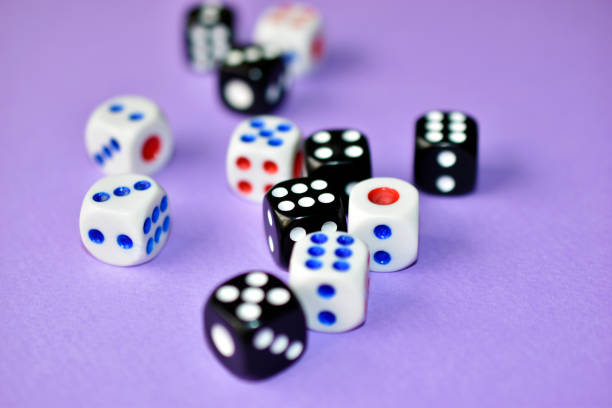 istock Dice  are black and white on a purple background 1339809538