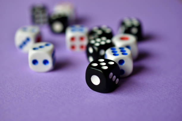 istock Dice  are black and white on a purple background 1339809539